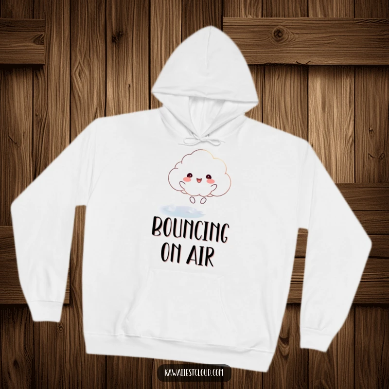 Funny hoodie showing a happy cloud character joyfully bouncing on a shimmering, ethereal surface, perfect for staying cozy.